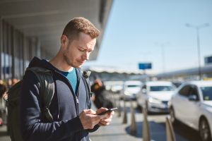 Man using phone and waiting for taxi